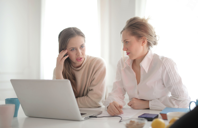Canva - Thoughtful businesswomen discussing problems in bright workspace.jpg